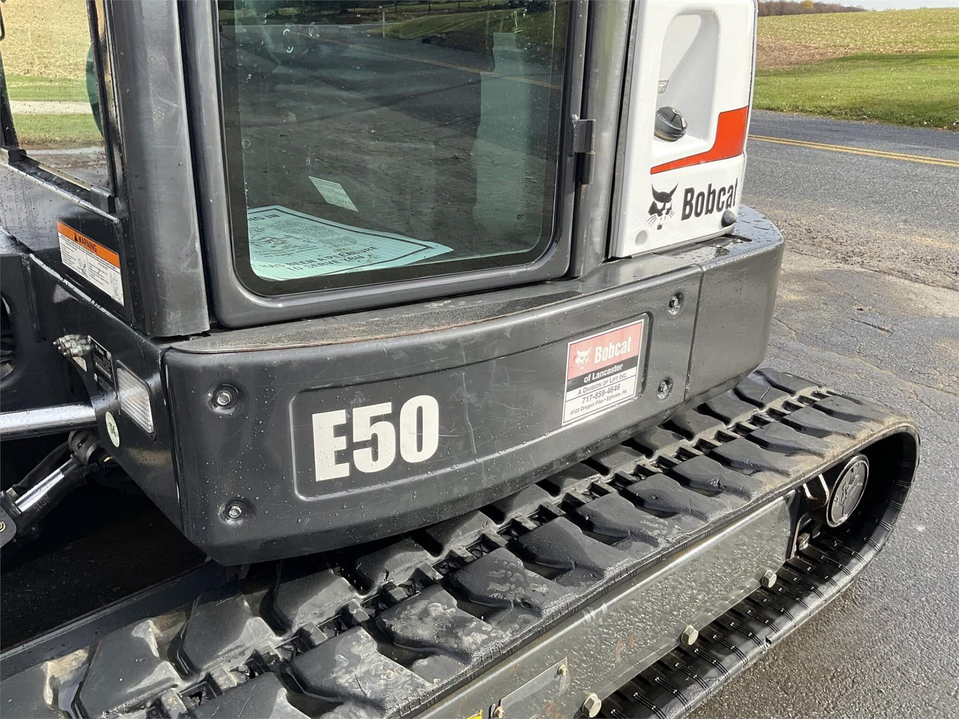 2012 Bobcat E50 — cab and rear panel close-up